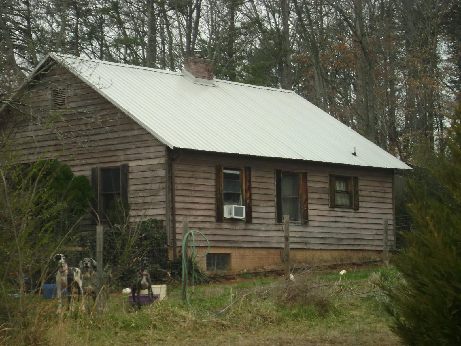 White metal roof on an old wood sided farmhouse, from a Asphalt Shingle Roof Repair job in Kings Mountain